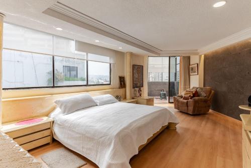 a bedroom with a large bed and a window at Penthouse Lomas de Chapultepec in Mexico City