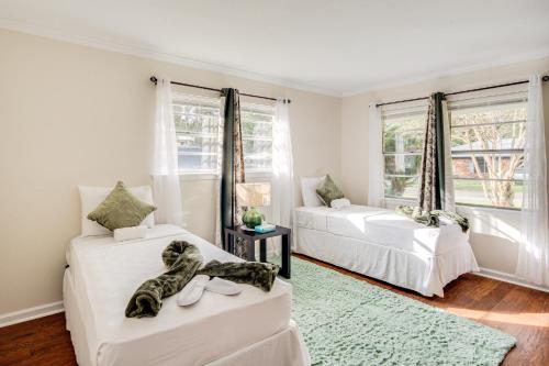 two beds in a room with two windows at 2 Mi to Beach and AFB Family Home in Biloxi in Biloxi
