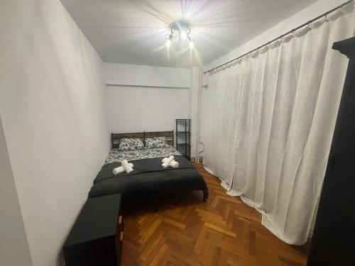 a bedroom with a bed with two stuffed animals on it at Apartament City Center Craiova in Craiova