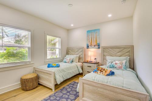 two beds in a room with two windows at Heated Pool, Mini Golf and Cabana Bradenton Retreat in Bradenton