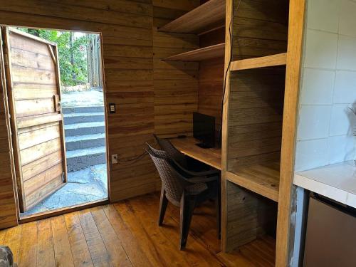 a room with a desk with a computer and a window at Roatan Bed & Breakfast Apartments in West End