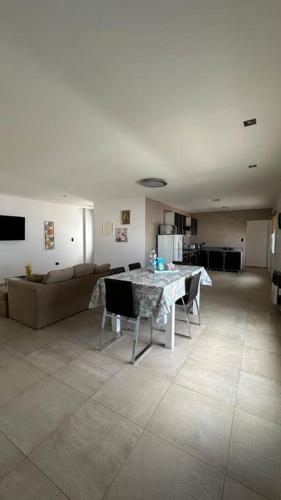 a living room with a table and a couch at 2A Estepa Apart-centro costanera in Comodoro Rivadavia