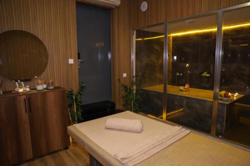 a room with a towel sitting on a table with a window at The Hera Platinum Hotel in Istanbul