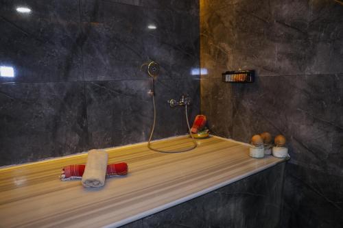 a bathroom with a shower with a wooden counter at The Hera Platinum Hotel in Istanbul