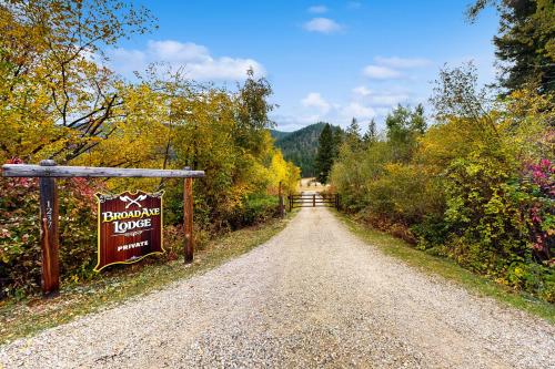 a dirt road with a sign that reads upcoming lodge at Broad Axe - Cabin #2 - Black Bear in Sula