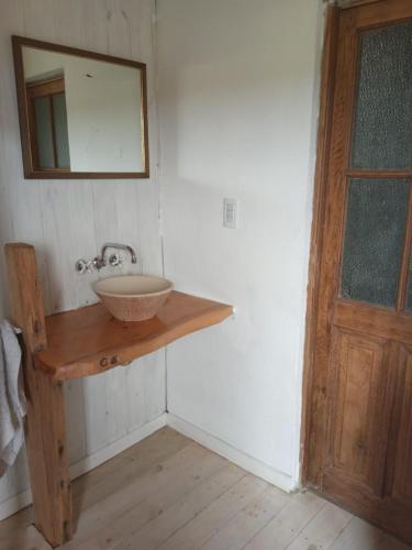 a bathroom with a sink and a mirror on a wall at Fisker in Mar del Plata