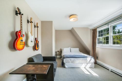 a bedroom with a bed and guitars on the wall at 4BR 3BA Hot Tub Media room Weekly rates in Montauk