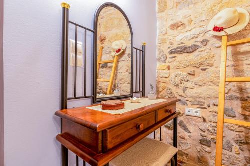 a bathroom with a wooden vanity with a mirror at Irene's Mansion in Vrontados