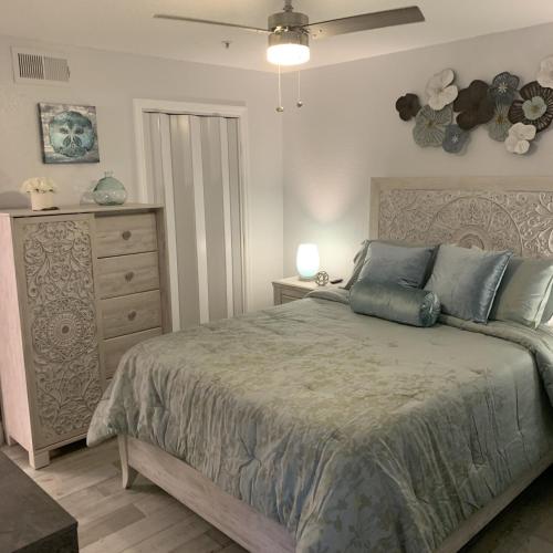 a bedroom with a large bed and a dresser at Villa del Sol in Kissimmee