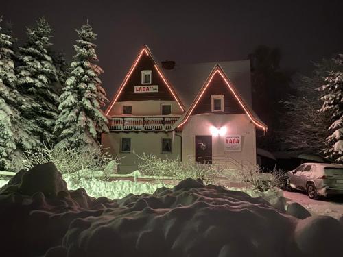 a large building with lights on the side of it at Horská chata LADA in Loučná pod Klínovcem