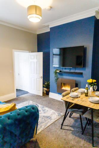 a living room with a table and a fireplace at 3Bed Cottage - WiFi & Parking - Perfect for Contractors in Sunderland