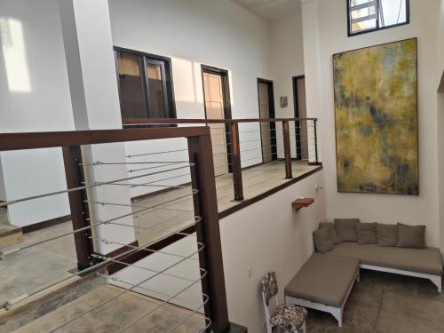 a living room with a staircase and a couch at Casa El Encanto in Curití