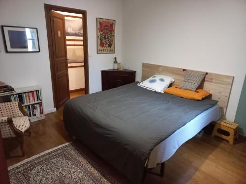 - une chambre avec un lit doté d'un oreiller orange dans l'établissement Les Coustous, à Bagnères-de-Bigorre