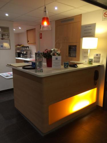 a kitchen with a counter with lights on it at Ibis budget Verdun in Verdun