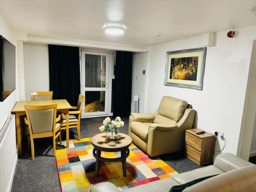 a living room with a couch and a table at 1 Luxe Bed Apt GView Derby City in Derby