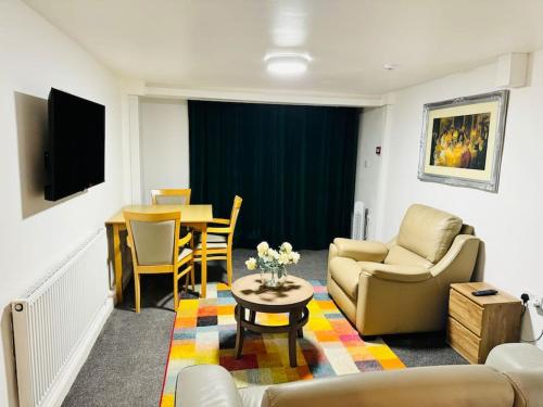 a living room with a couch and a table at 1 Luxe Bed Apt GView Derby City in Derby