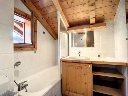a bathroom with a tub and a sink and a shower at Résidence Ch. Col De La Lune - Grand chalet avec terrasse et jacuzzi MAE-4544 in Les Allues