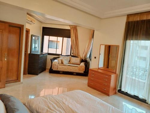 a bedroom with a bed and a dresser in it at Family Apartment with Pool in Marrakech
