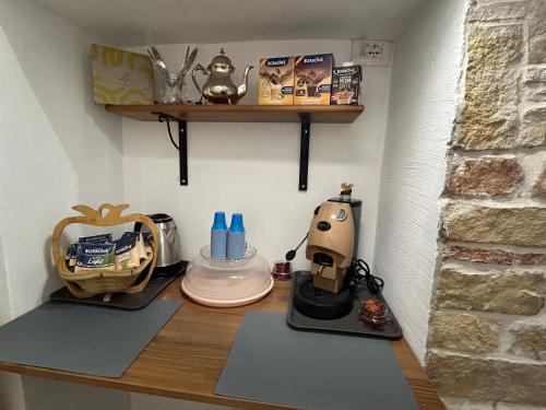 a kitchen counter with a coffee maker on it at Farrose in Naples
