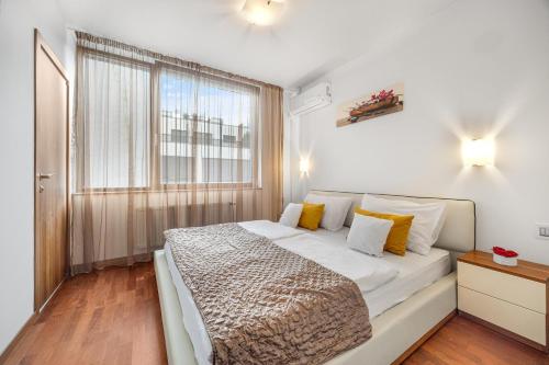 a bedroom with a large bed and a window at REVON Business apartment 50 Dunajská, Free Parking in Bratislava