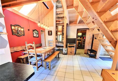 une salle à manger avec une table en bois et des escaliers dans l'établissement Résidence La Louviere - Appartement dans Chalet pour 12, proche pistes MAE-6671, à Villarembert