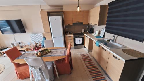 a kitchen with a table and a dining room at Beachfront Penthouse with Seaview in Lefkandi Chalkidas