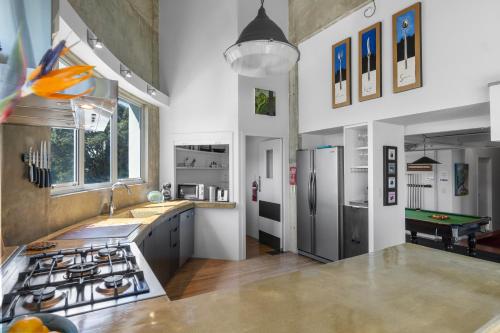 a kitchen with a sink and a stove top oven at The Silos Apartments in Raglan