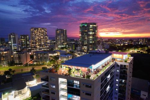 a view of a city skyline at night at Ramada Suites by Wyndham Zen Quarter Darwin in Darwin