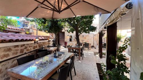 a patio with tables and chairs and an umbrella at Villa Citronella Boutique Hotel in Antalya