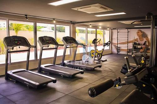 a gym with a bunch of tread machines in it at Puerto Ventura Cabo Branco Genius Flats in João Pessoa