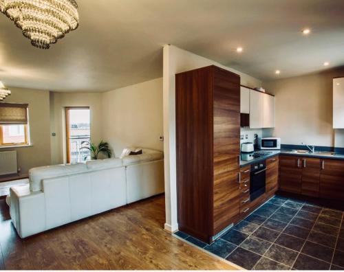a living room with a couch and a kitchen at Cozy City Escape in Norwich in Norwich