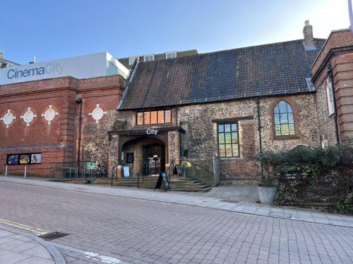 an old brick building on the side of a street at Cozy City Escape in Norwich in Norwich