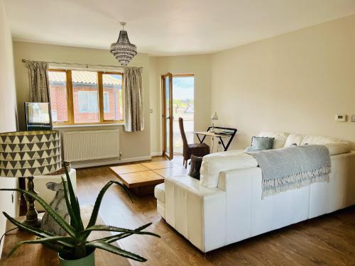 a living room with a white couch and a table at Cozy City Escape in Norwich in Norwich
