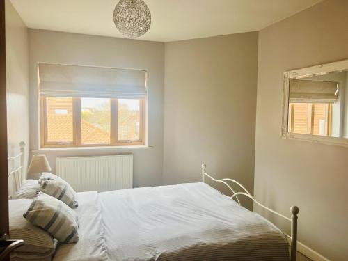 a bedroom with a white bed and a window at Tranquil Apartment in Norwich City Center in Norwich