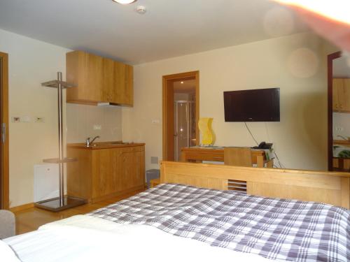 a bedroom with a bed and a flat screen tv at Apartment 116 in Jahorina