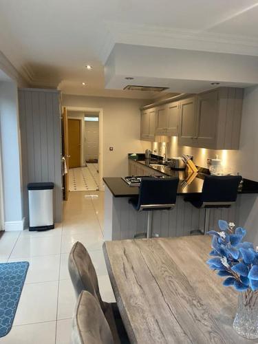 a kitchen with a table and chairs in a room at Beautiful town house in the heart of Knutsford in Knutsford