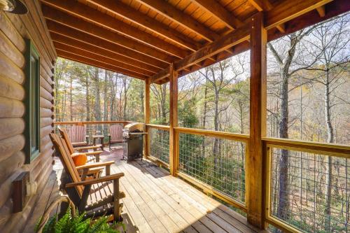 a screened in porch with two chairs and a grill at Cabin on 22 Acres with Patio - 3 Mi to Blowing Rock! in Lenoir