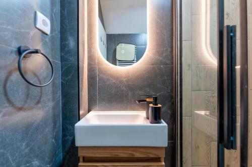 a bathroom with a white sink and a mirror at Apartman Vuk Zlatibor in Zlatibor
