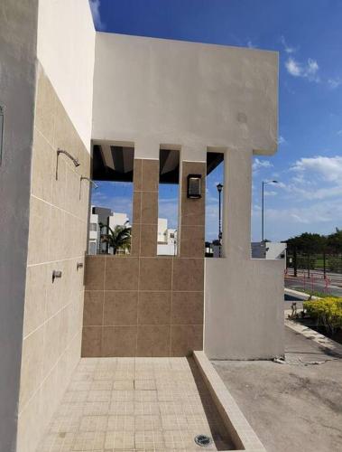 a building with a shower in the side of it at Cómoda casa en clúster privado in El Jobo