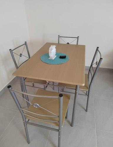 a table with two chairs and a napkin on it at Cómoda casa en clúster privado in El Jobo