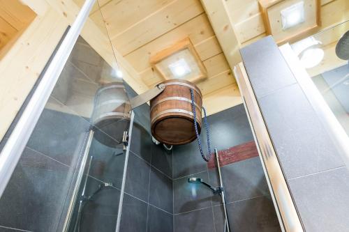 a barrel hanging from the ceiling of a bathroom at Rezydencja Na Szymoszkowej in Zakopane