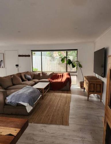 a living room with a couch and a table at Family beach house among the gum trees in Ocean Grove