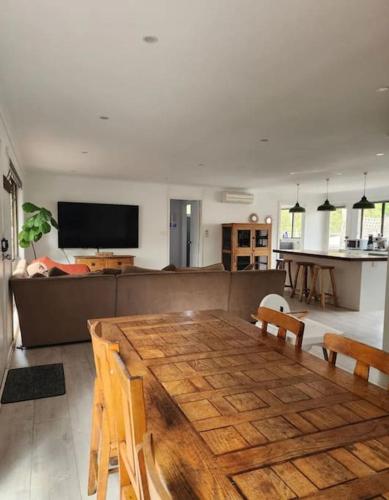 a living room with a wooden table and a couch at Family beach house among the gum trees in Ocean Grove