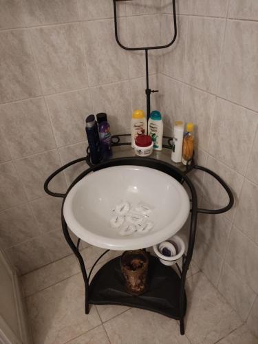 a white sink in a bathroom with a shelf at Loft Mansardato in Monza