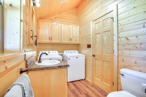 a bathroom with a sink and a washer and dryer at 17 Mi to Tarleton State Mtn-View Hideaway! in Stephenville