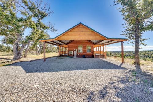 a wooden cabin with a pavilion in a field at 17 Mi to Tarleton State Mtn-View Hideaway! in Stephenville