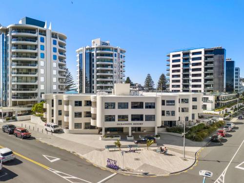 a city with tall buildings and a street with cars at Oceanside Retreat Mt Maunganui in Mount Maunganui