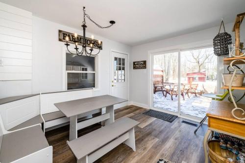 a dining room with a table and a window at Elm St Retreat - 3 Min walk to Downtown Three Oaks in Three Oaks