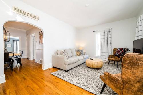 a living room with a couch and a table at Elm St Retreat - 3 Min walk to Downtown Three Oaks in Three Oaks