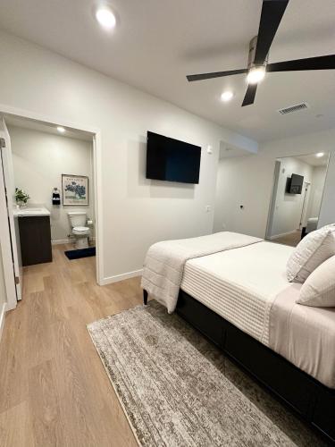 a bedroom with a bed and a flat screen tv at Nimitz Crossing Luxury Residences in San Diego